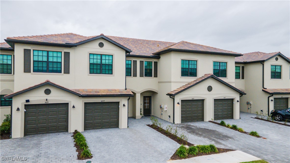 a front view of a house with a yard and garage