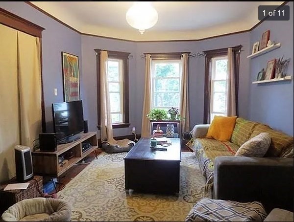 a living room with furniture and a flat screen tv