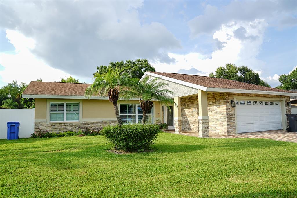 a front view of house with yard and green space