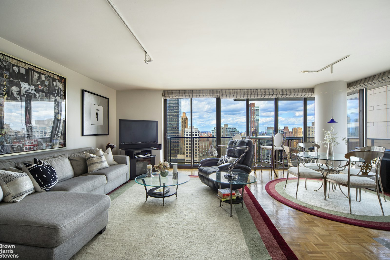 a living room with furniture and large windows