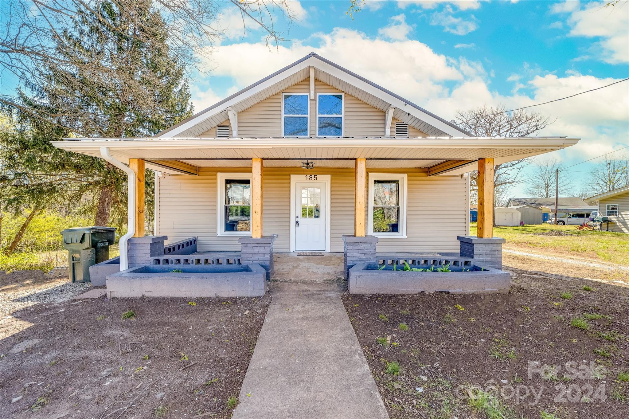 a front view of a house with a yard and an outdoor space