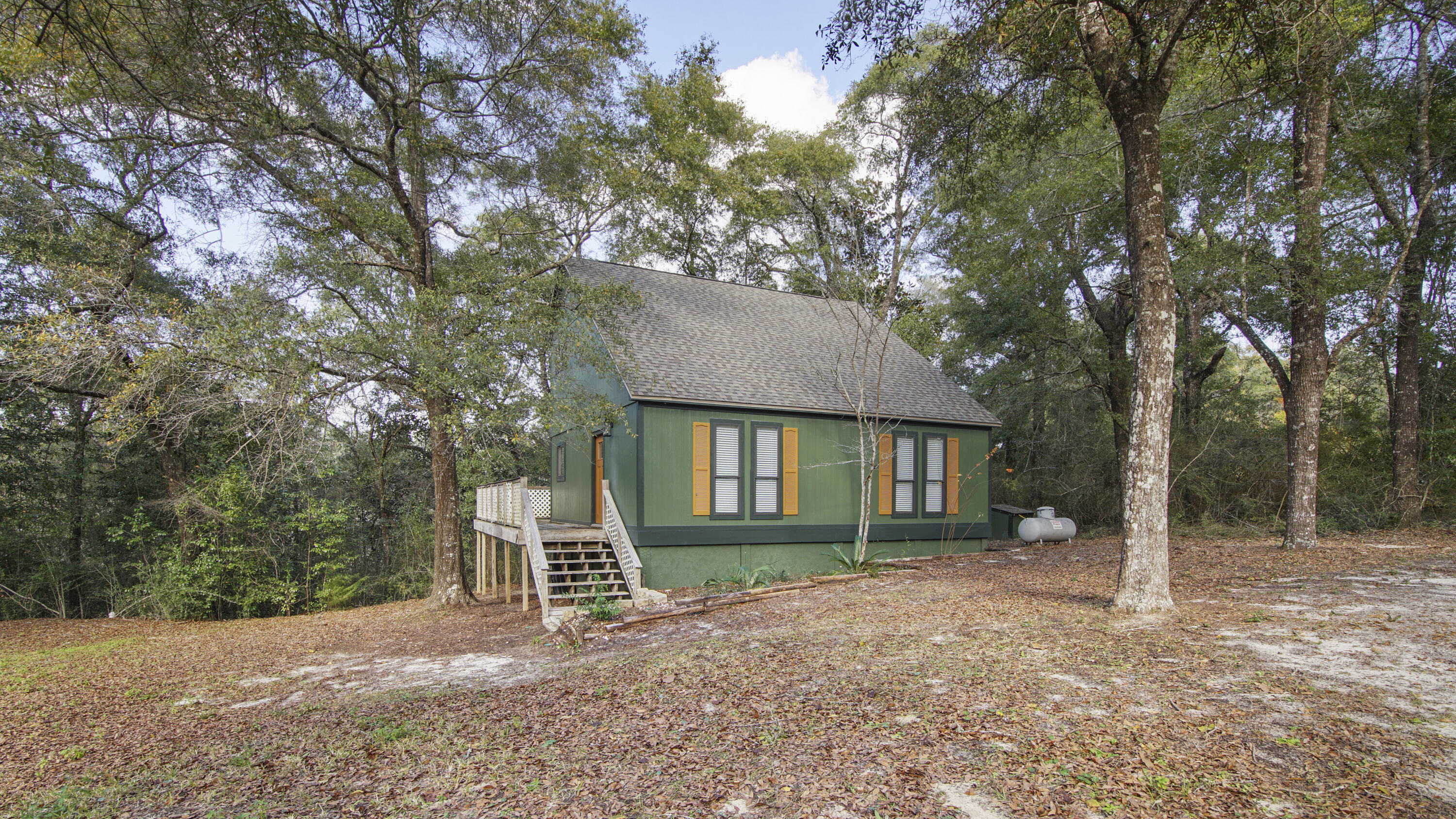 a front view of a house with a tree