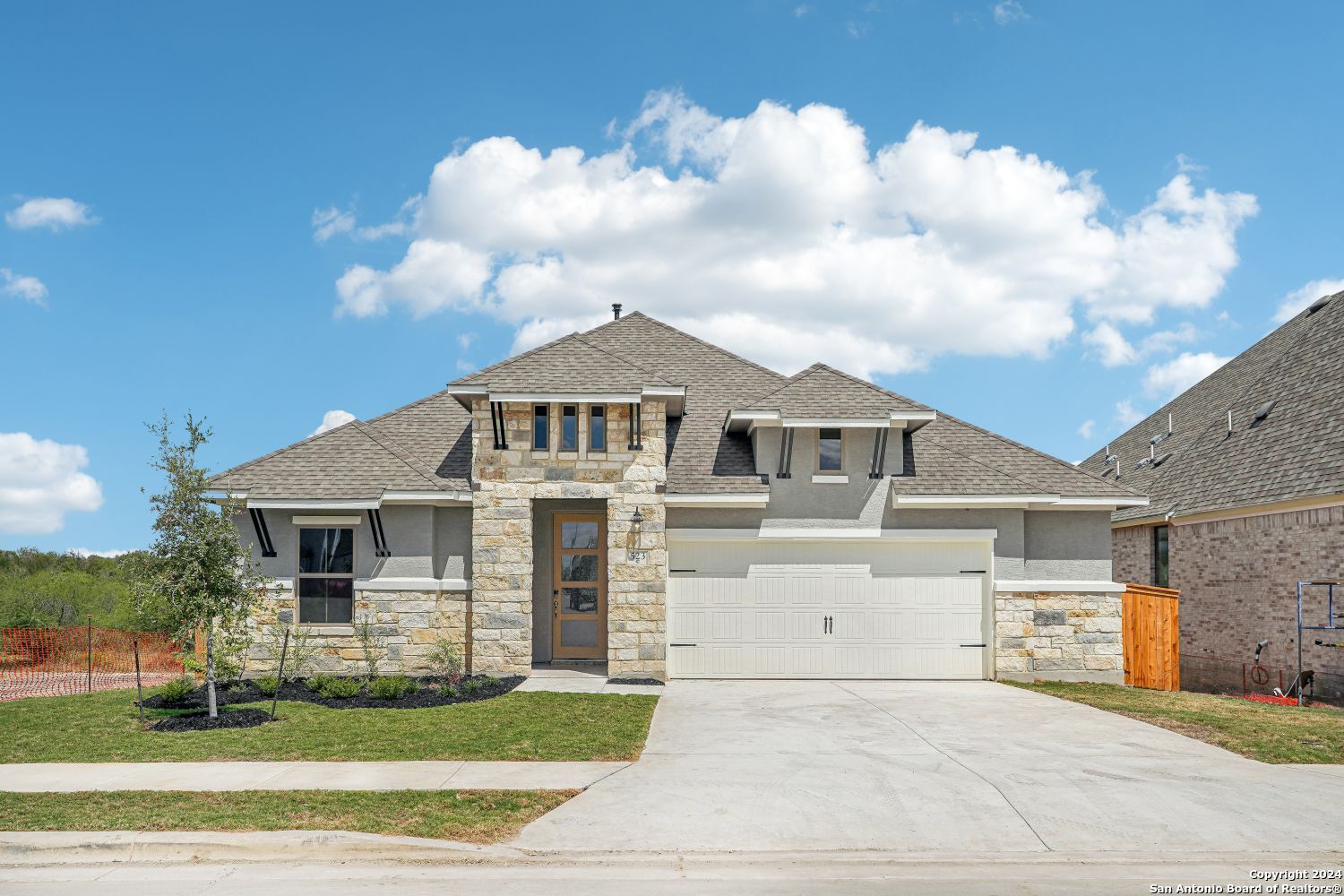 a front view of a house with a garden