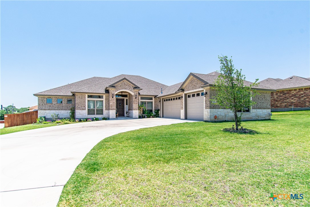 a front view of a house with a garden and yard