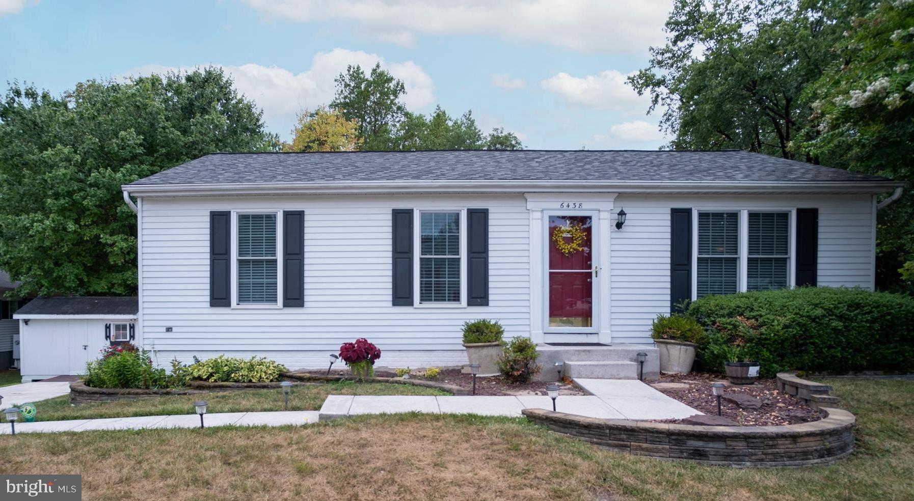 a view of a house with a yard and sitting area