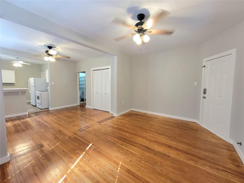 a view of a livingroom with a chandelier fan and a bathroom