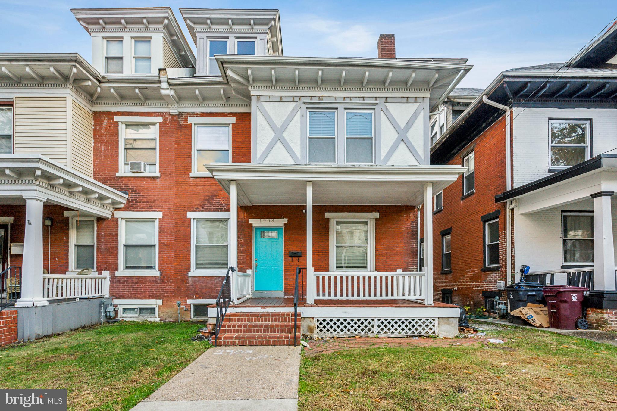 front view of a brick house with a yard