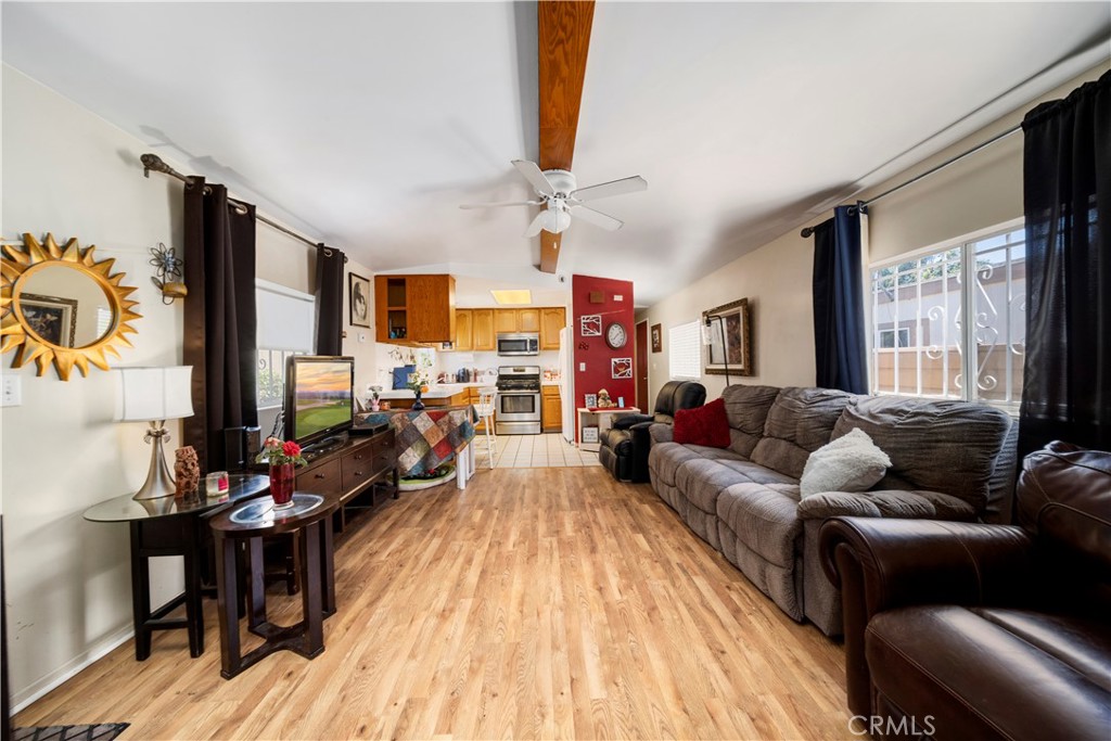 a living room with furniture fireplace and a large window