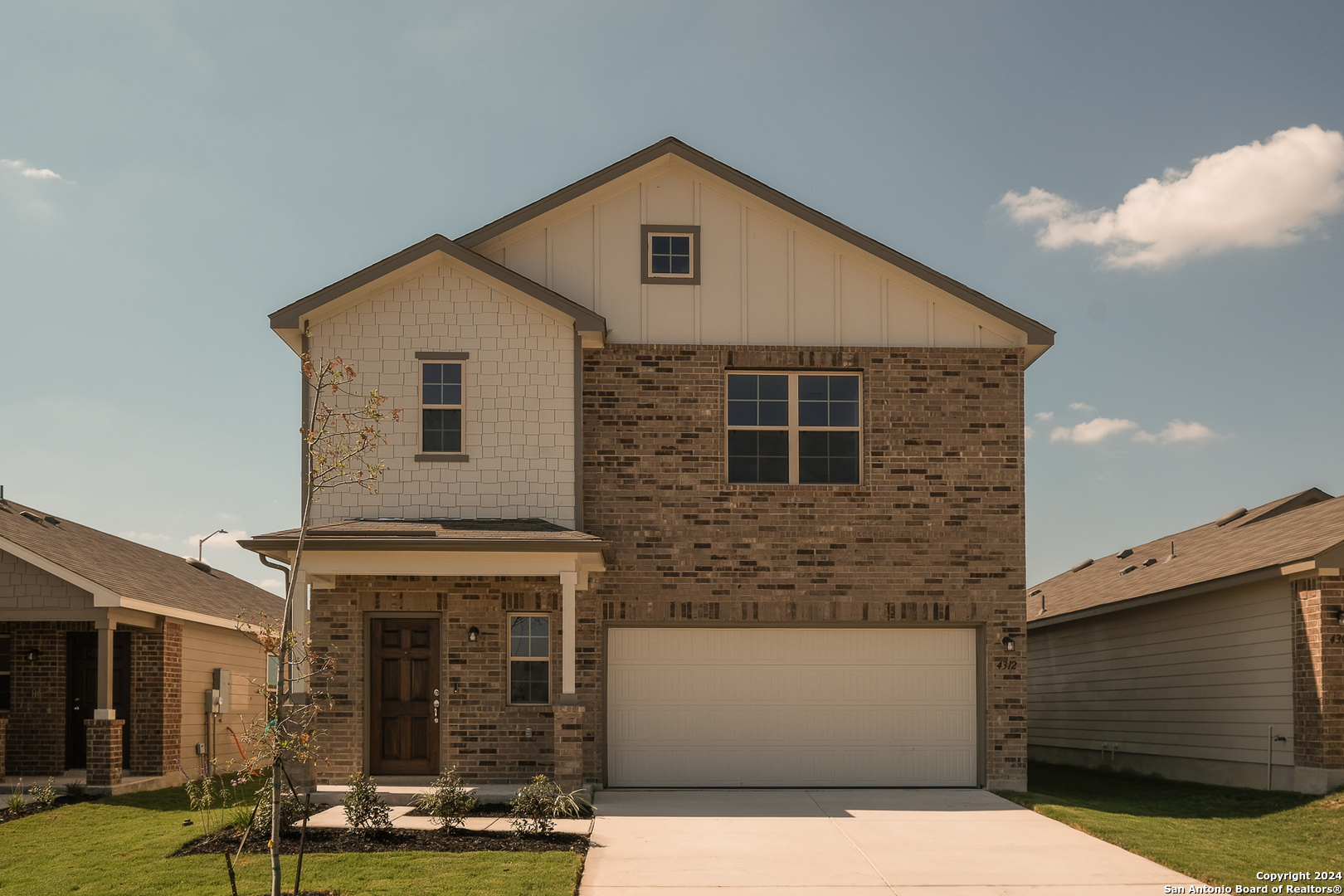 a front view of a house with a yard