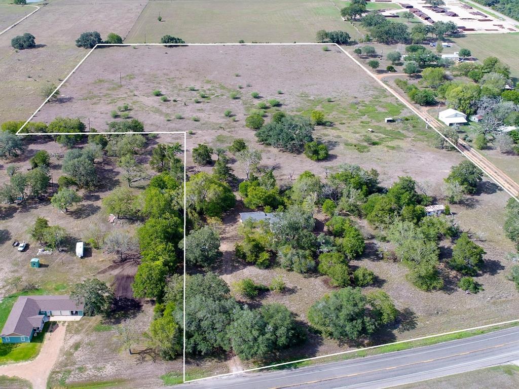 an aerial view of a house with a yard