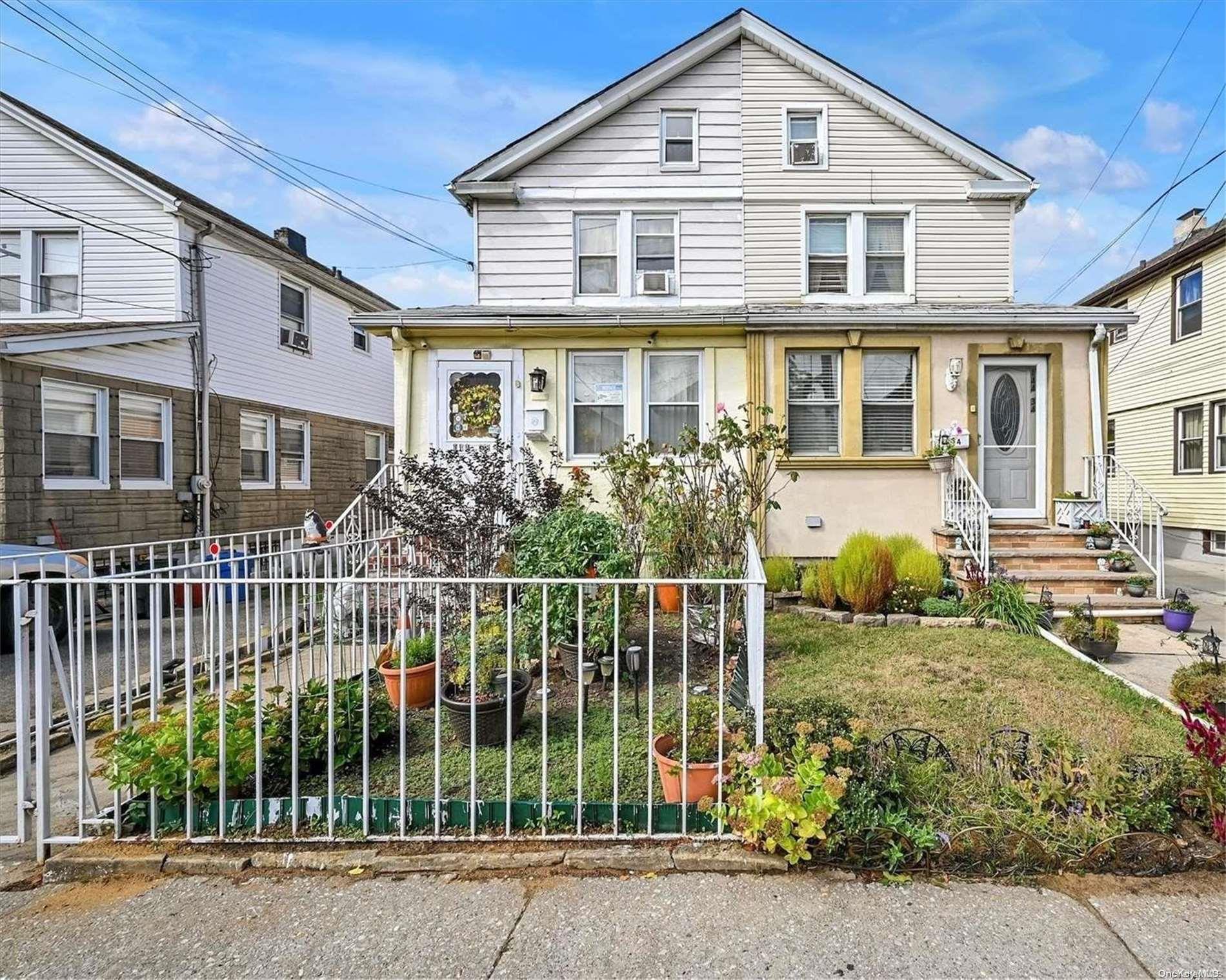 a front view of a house with plants and entryway