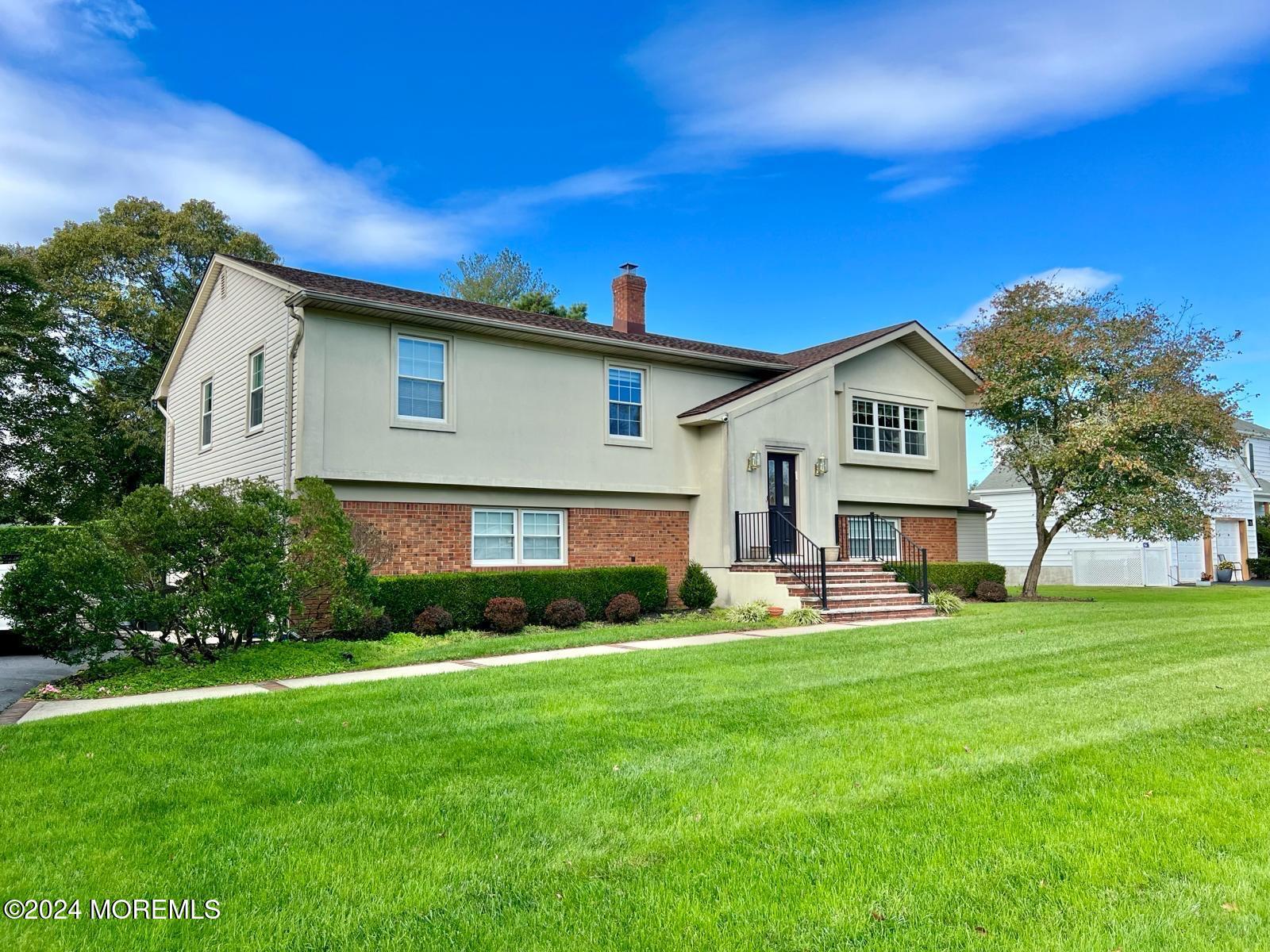 a front view of house with yard and green space