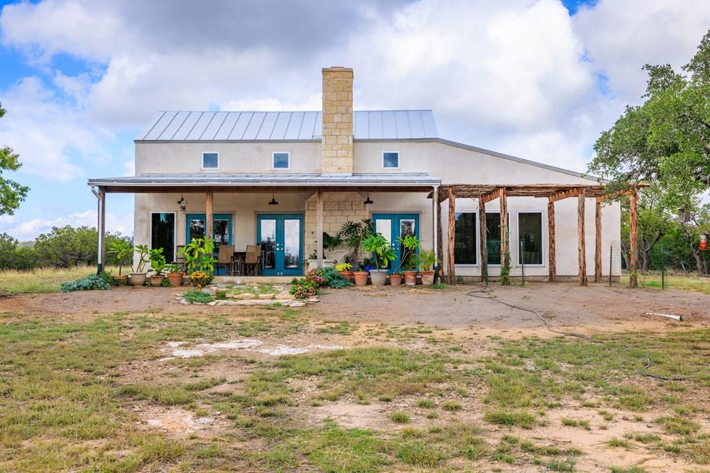 a view of a house with patio and a yard