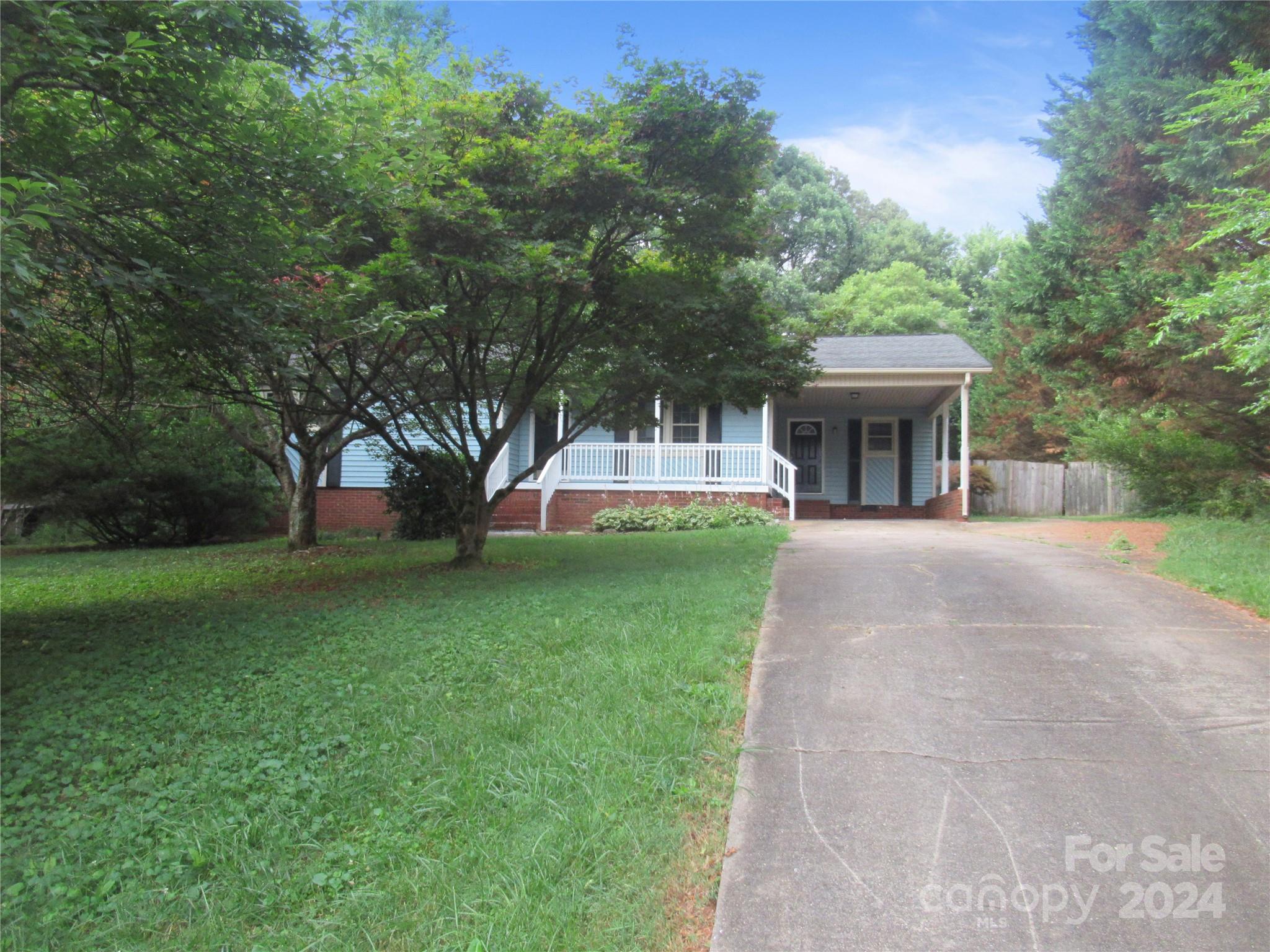 a view of house with outdoor space and garden