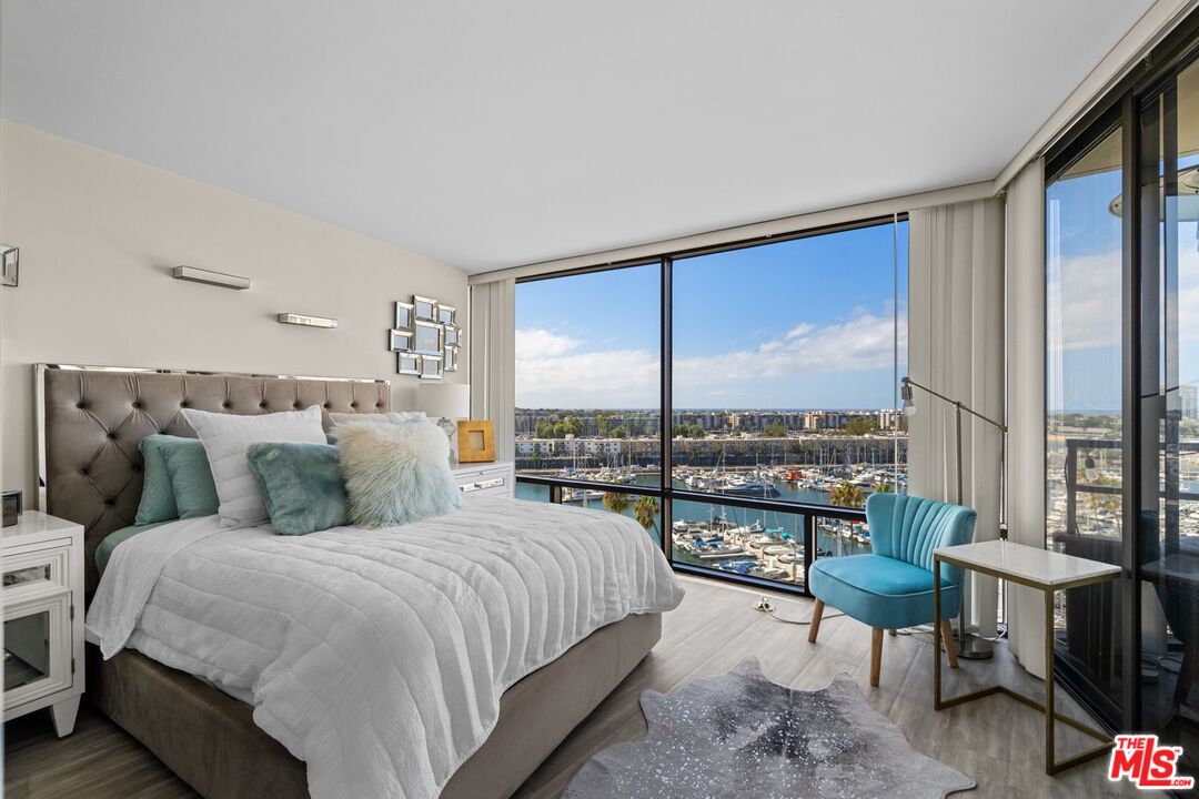 a bedroom with double bed and a large window