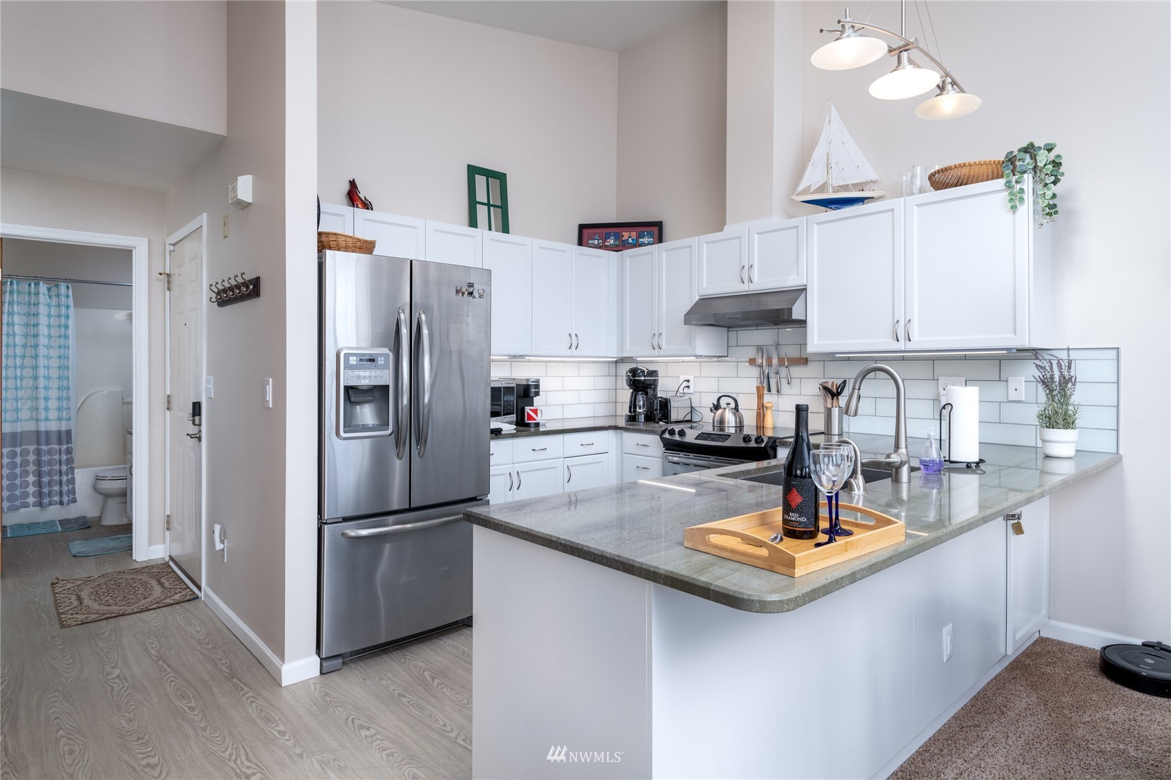 a kitchen with a refrigerator a sink and cabinets