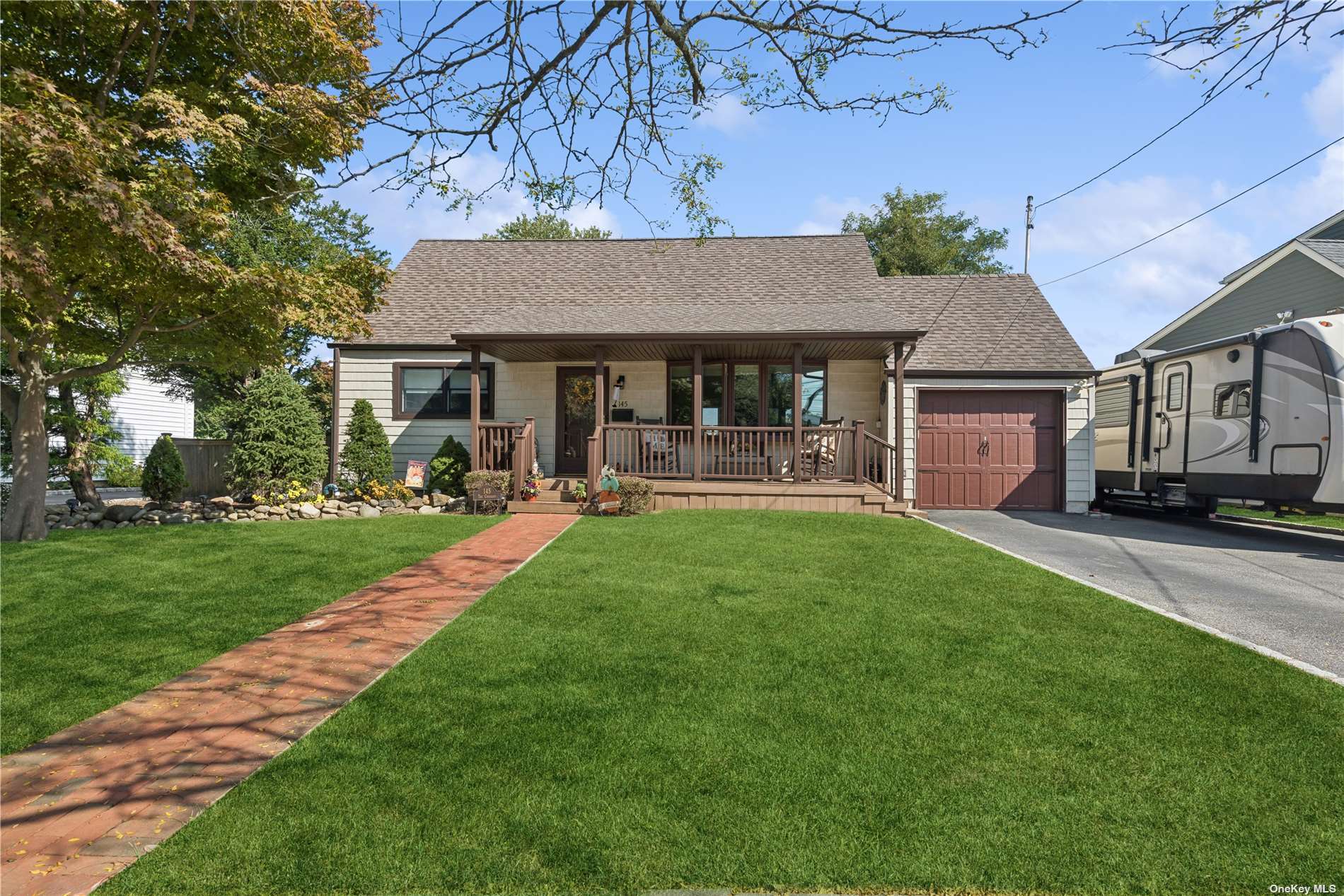 a front view of a house with a garden and patio