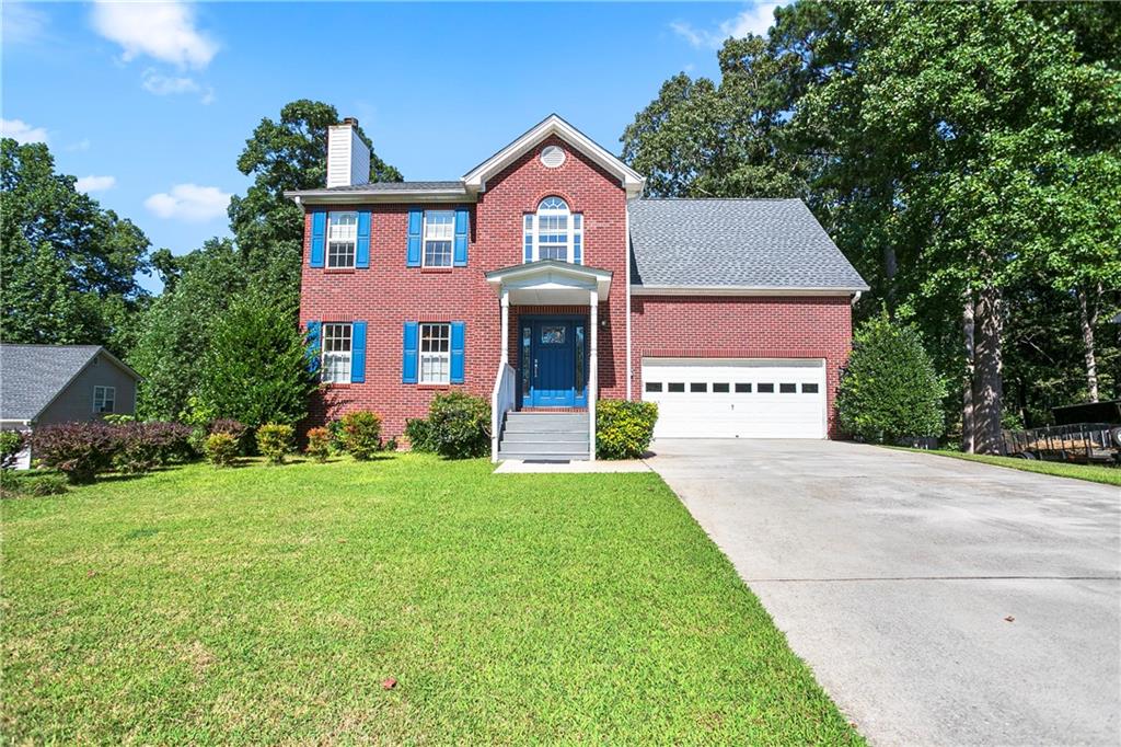 a front view of a house with yard