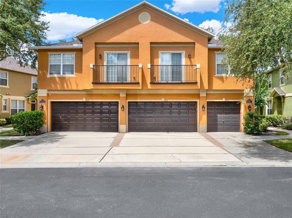 a front view of a house with a yard and garage