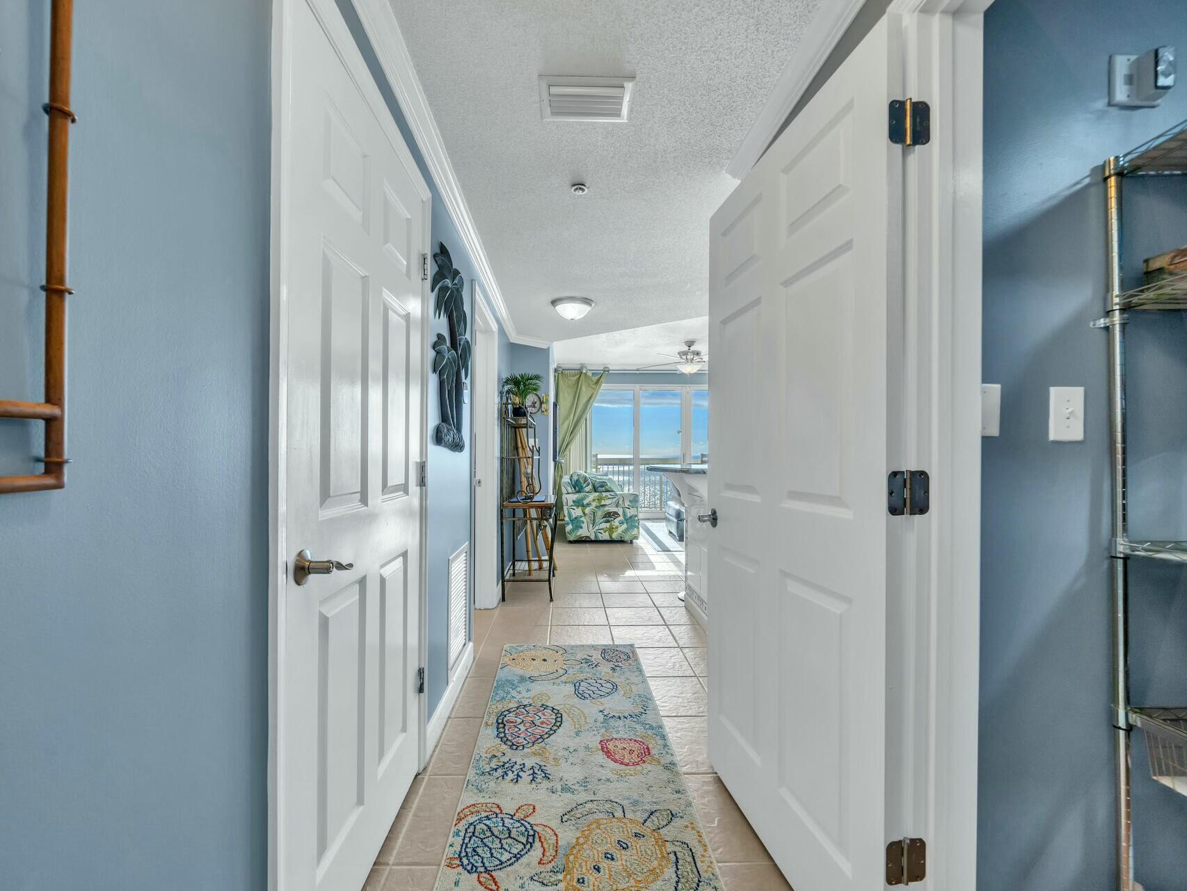 a hallway with a dining table and chairs