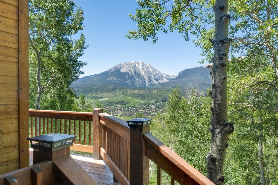 a view of a balcony with wooden fence and floor