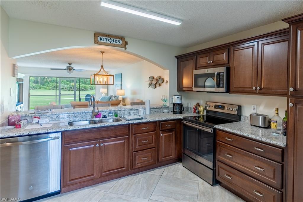 a kitchen with a sink stove and microwave