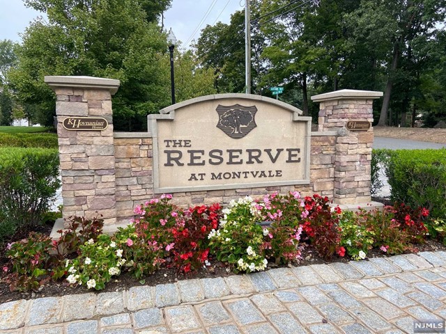 a view of sign board with flower plants