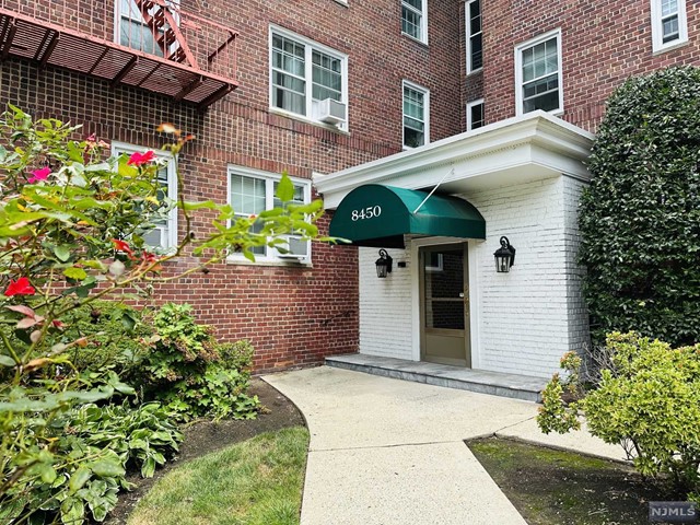 a view of a house with potted plants