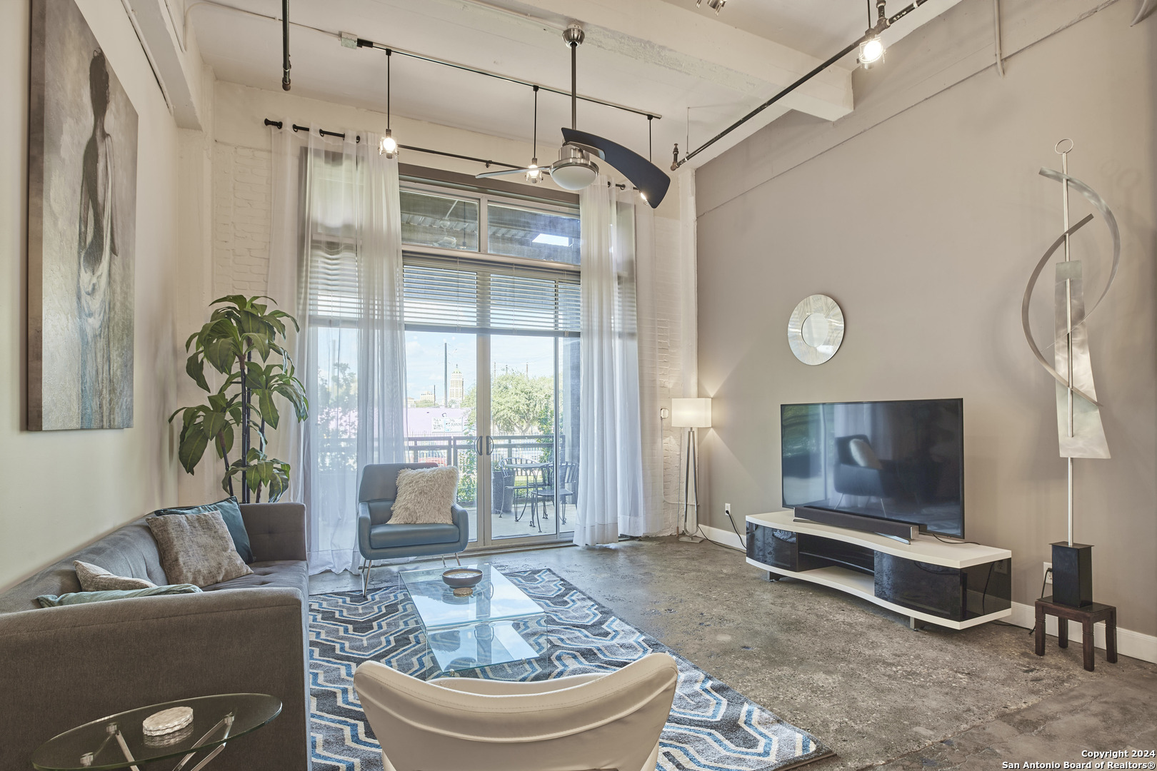 a living room with furniture and a flat screen tv