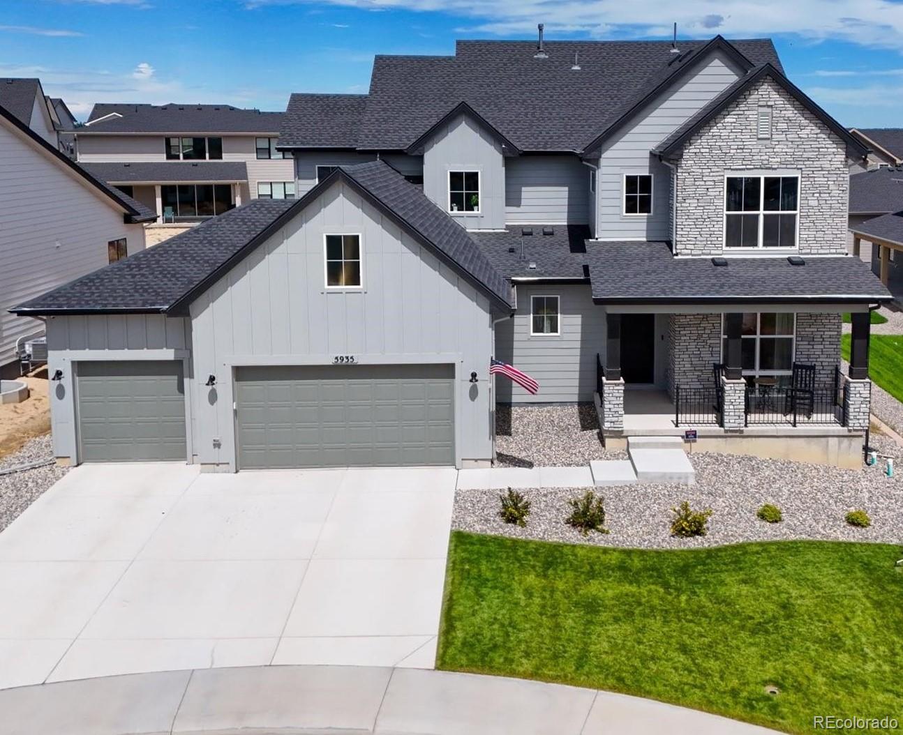 a front view of a house with a yard outdoor seating and garage