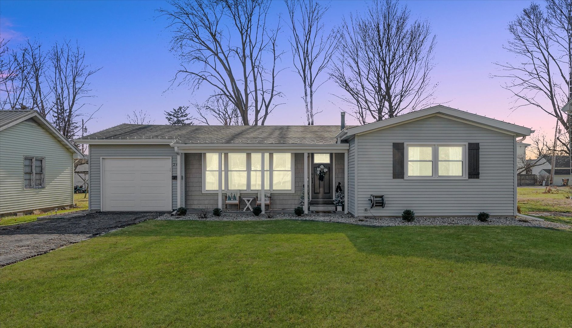 a front view of a house with a garden and yard