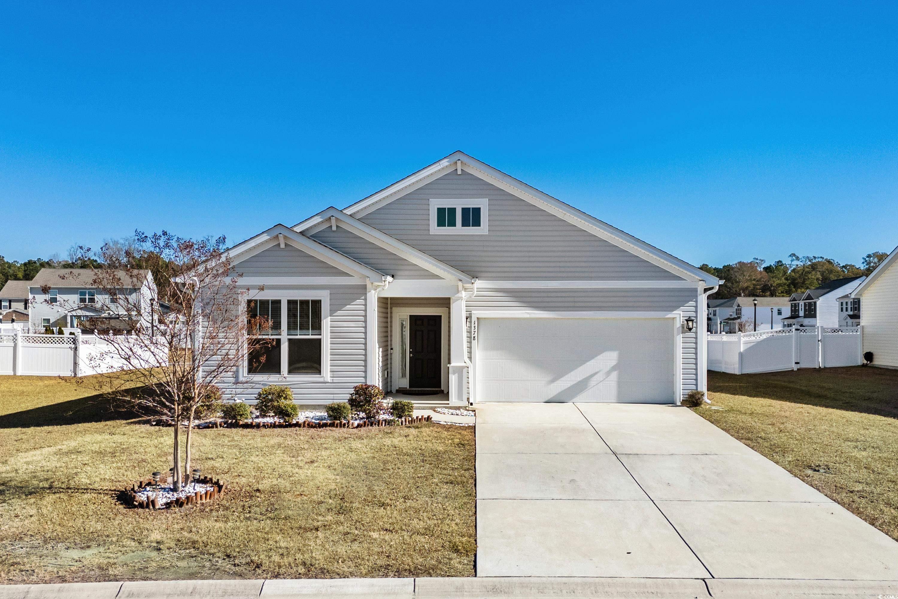 View of front facade featuring a garage and a fron