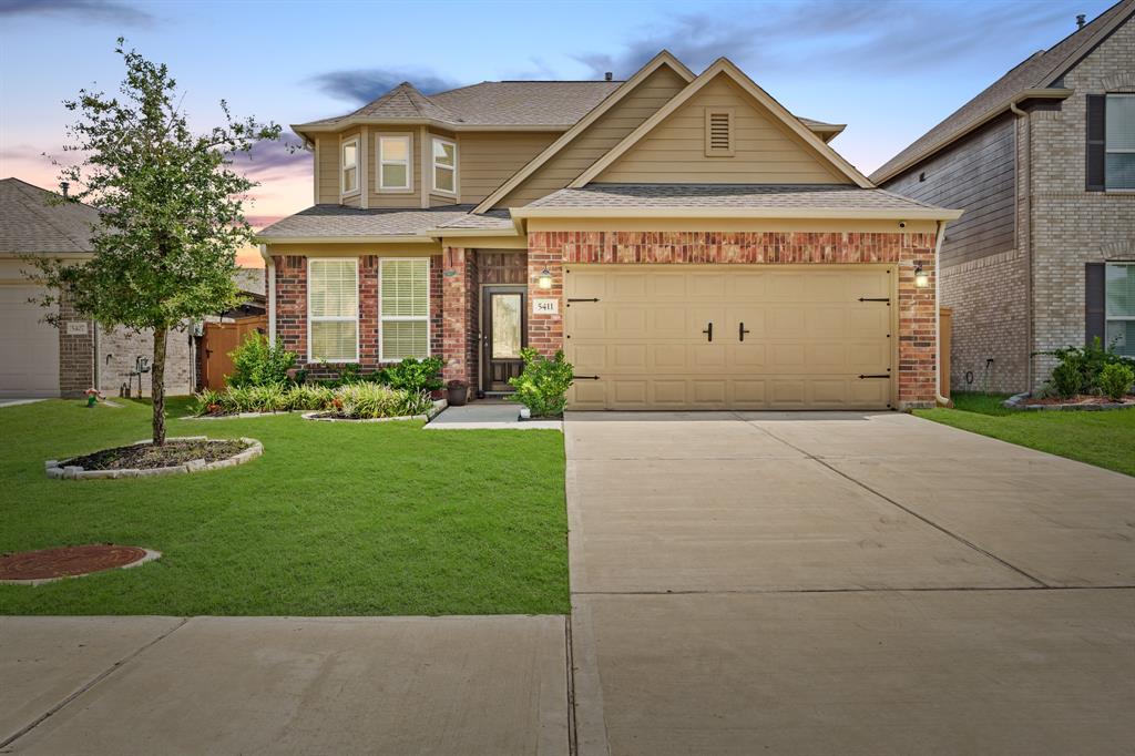 a front view of a house with a garden and plants