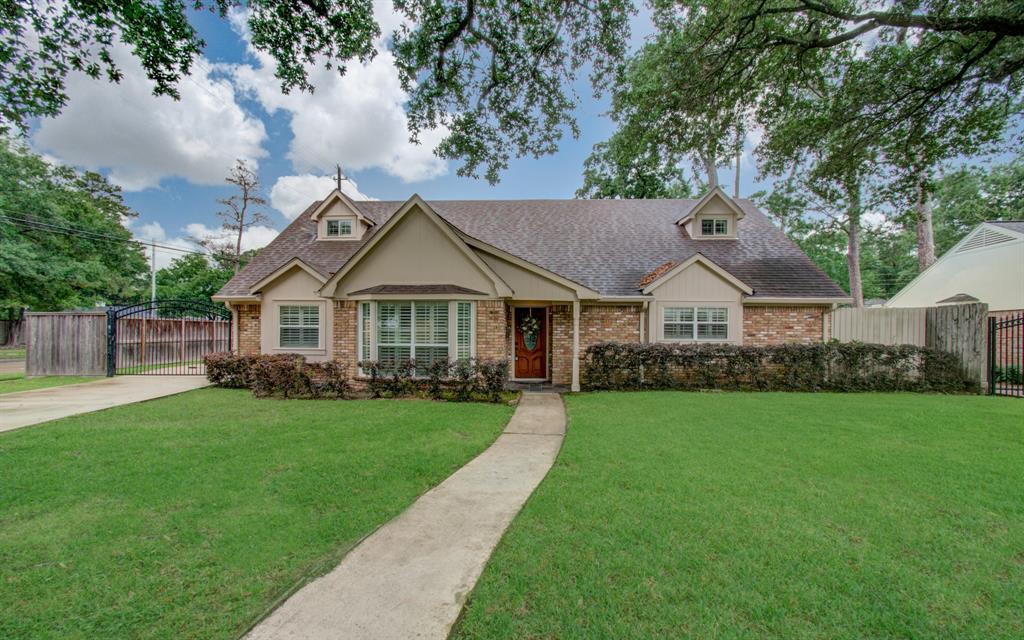 a front view of a house with yard and green space