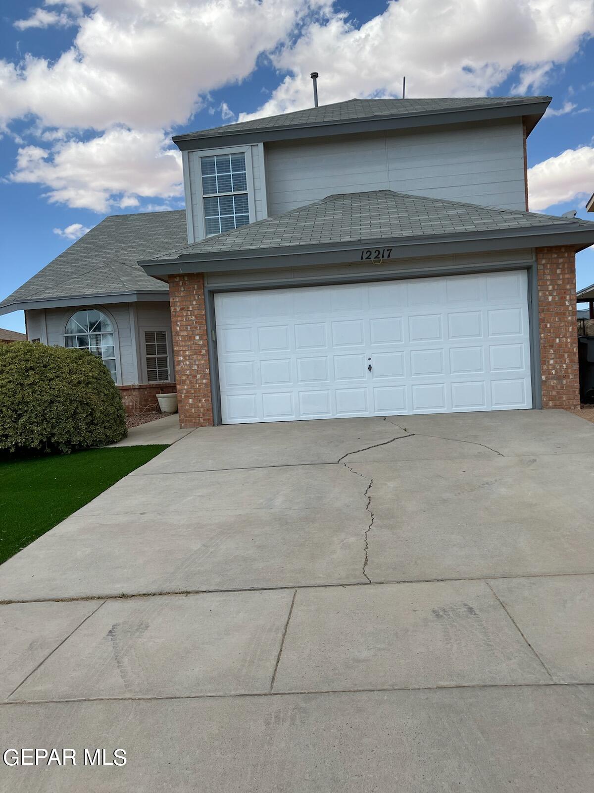 a front view of a house with garage