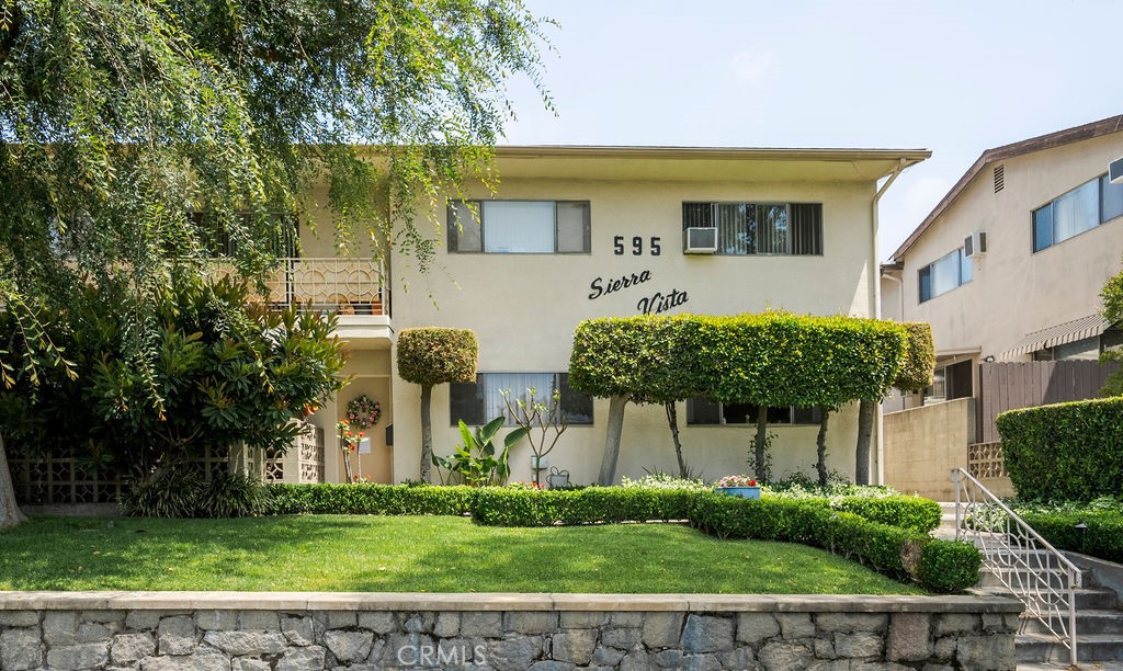 a front view of a house with a garden