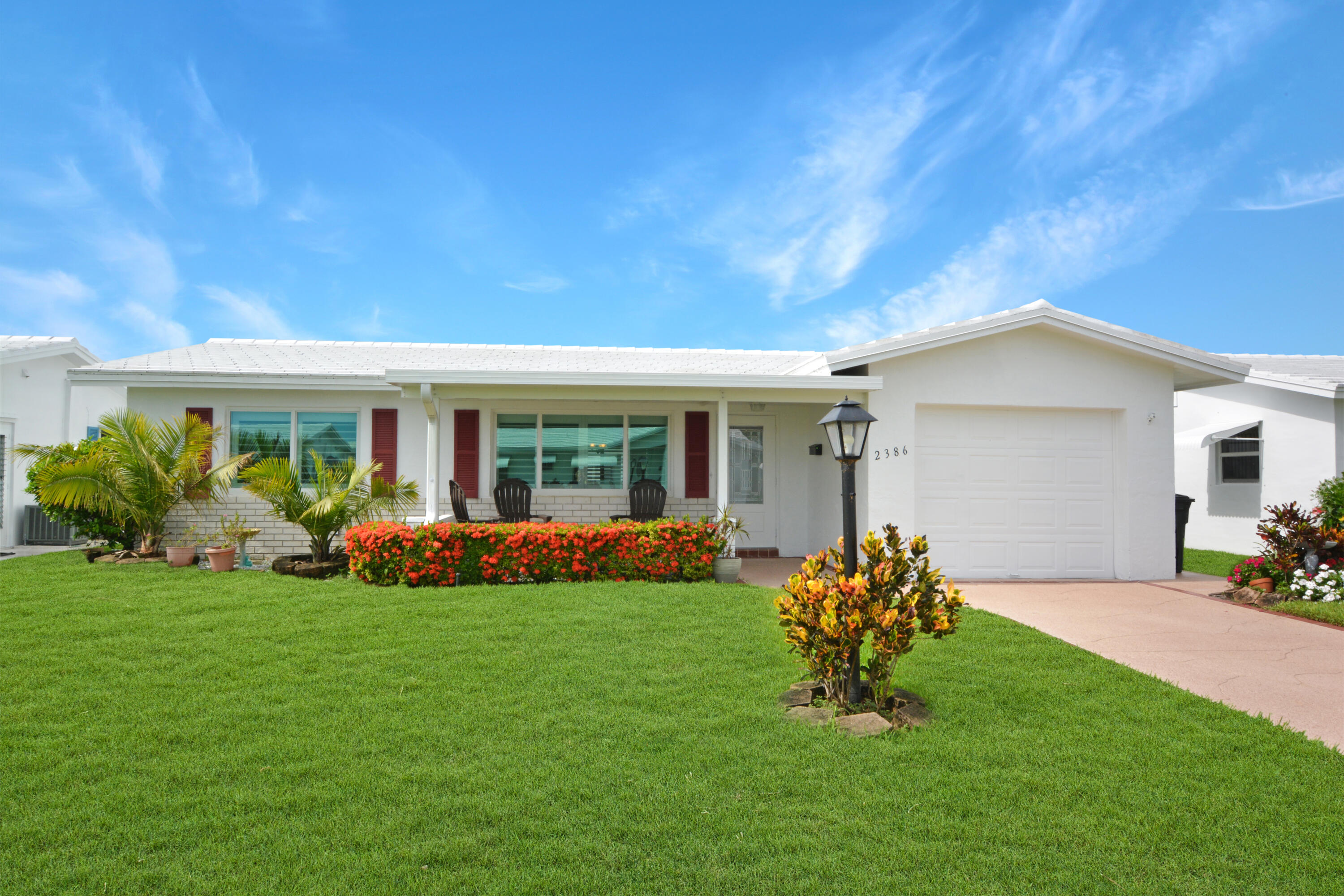 a front view of house with a garden and patio