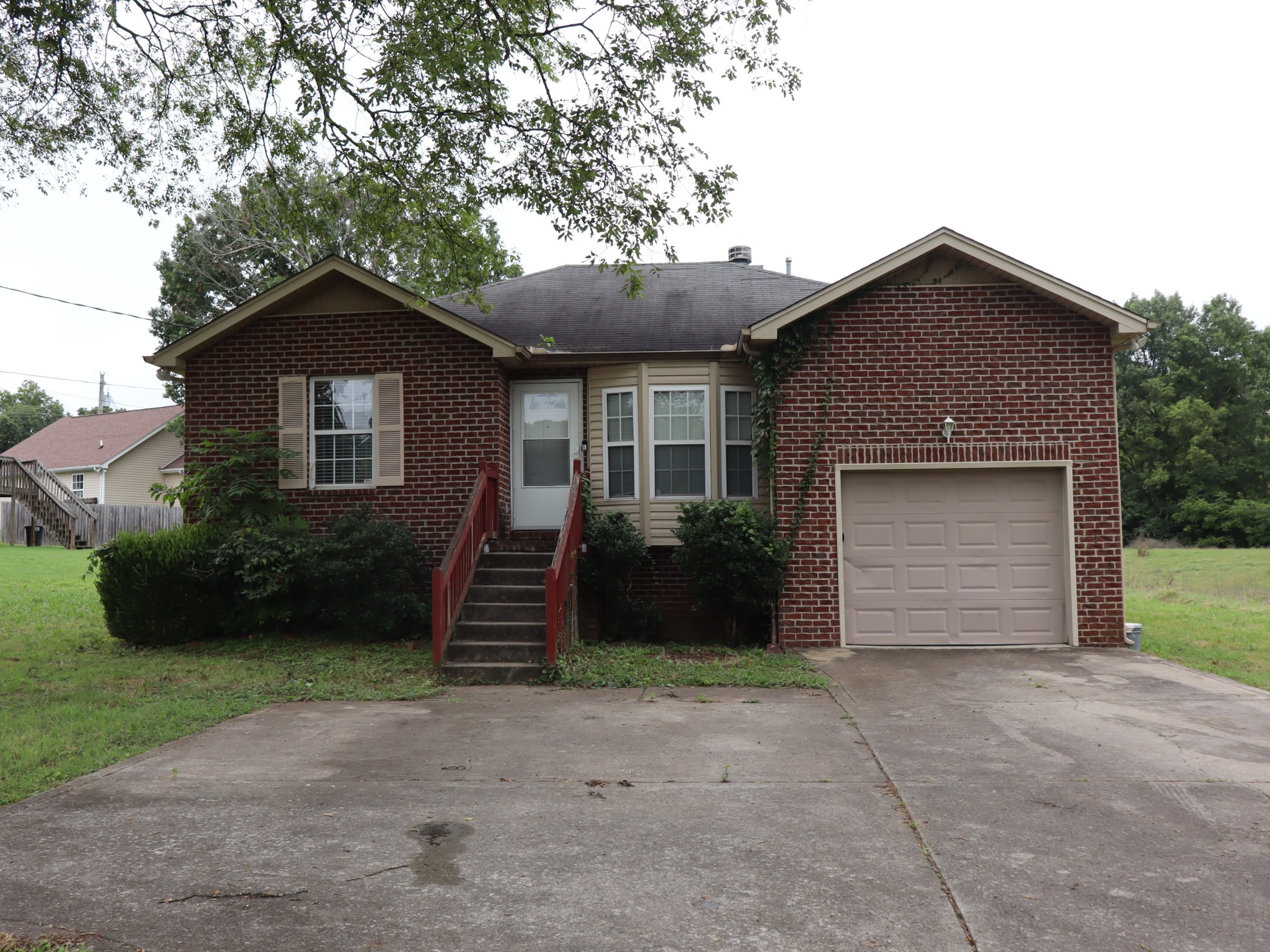 a front view of a house with a garden and garage