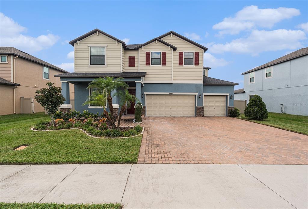 a front view of a house with a yard and garage