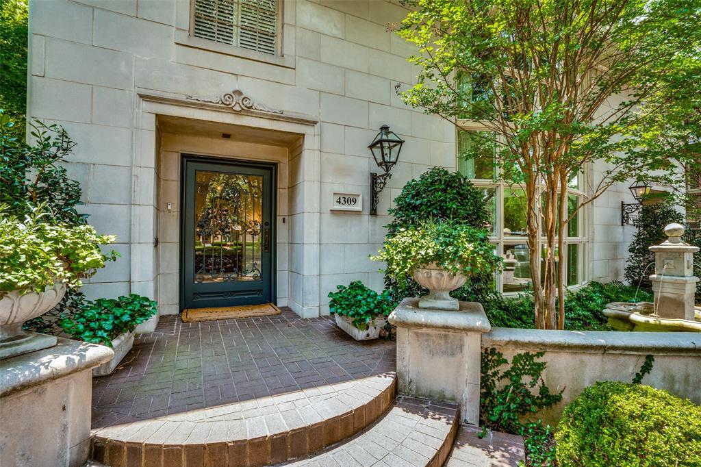 a view of a house with potted plants