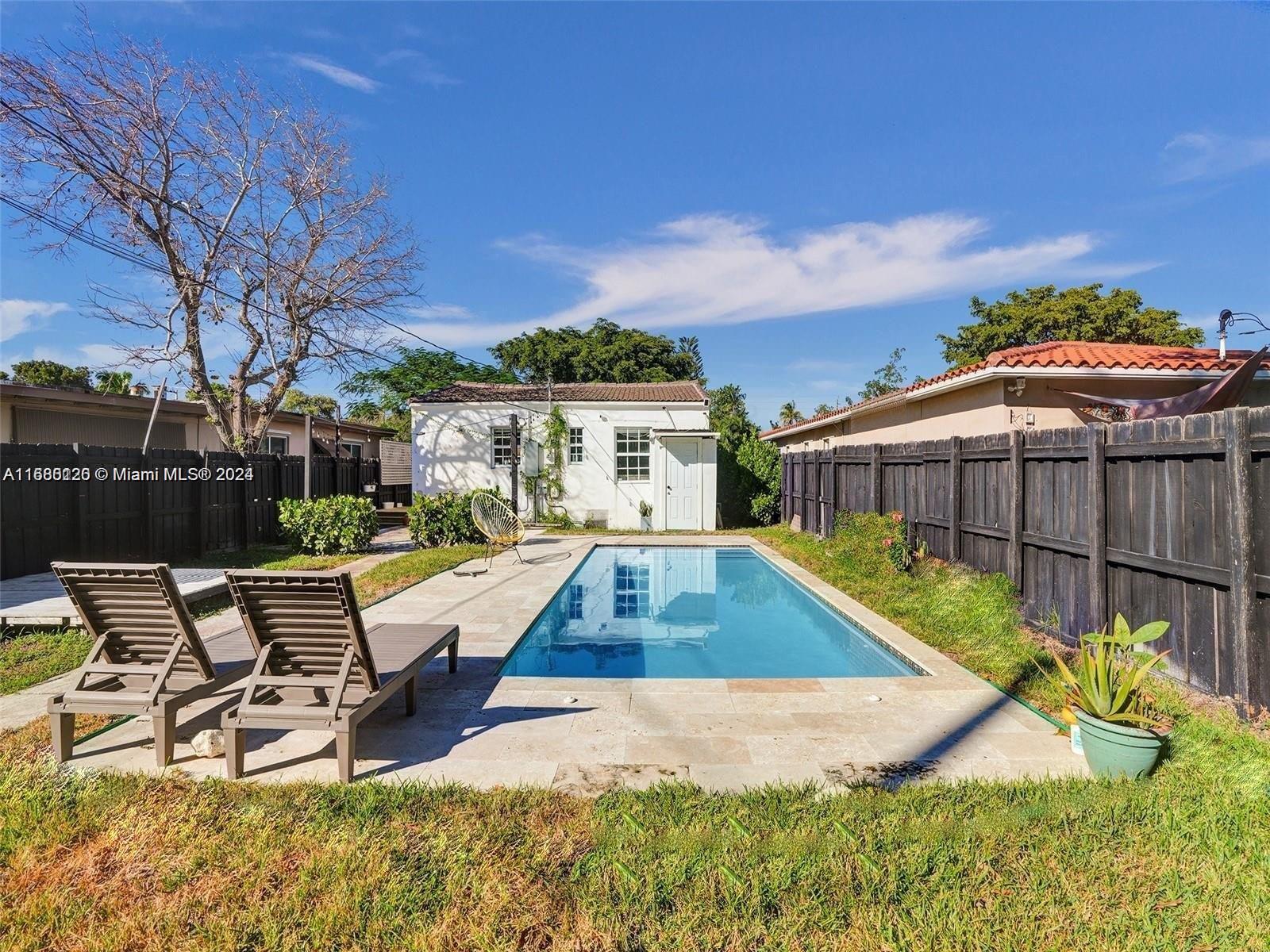 a view of a swimming pool with lounge chair