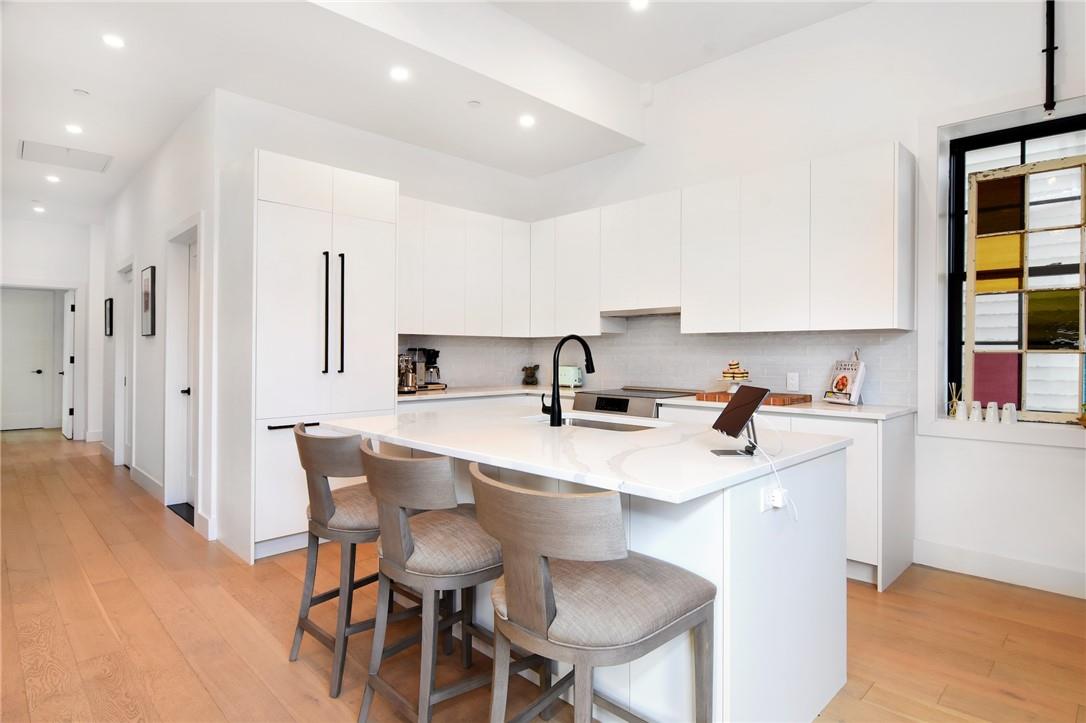 a kitchen with stainless steel appliances a sink and a table