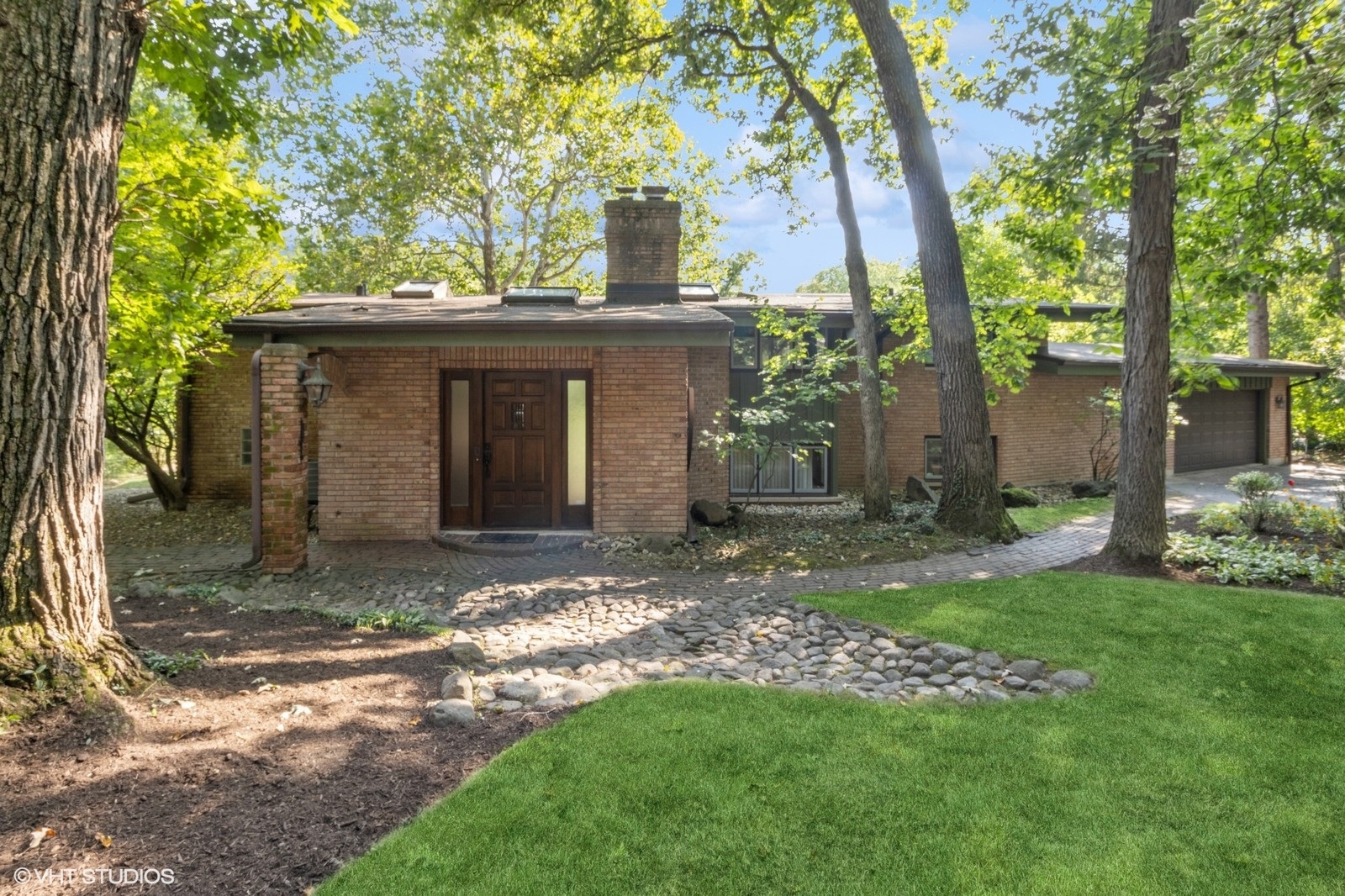 a view of a house with a yard and tree s