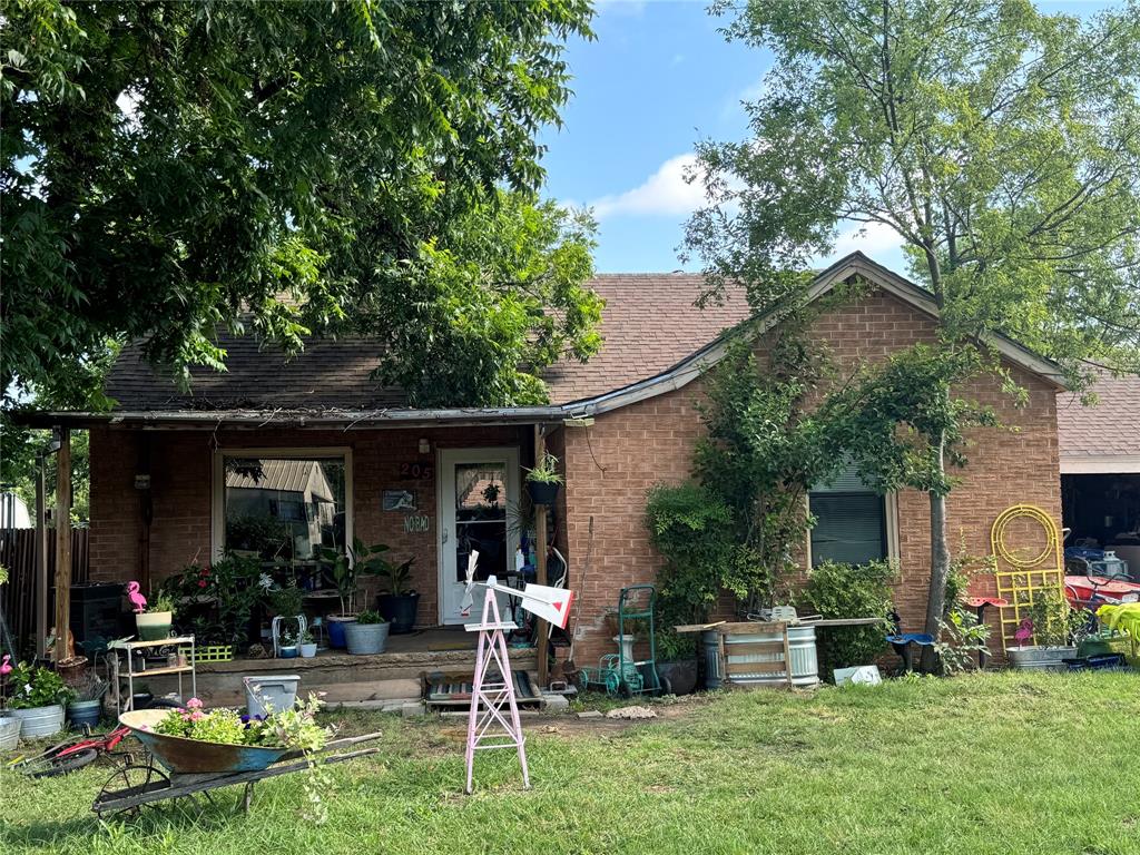 a view of a house with backyard porch and sitting area