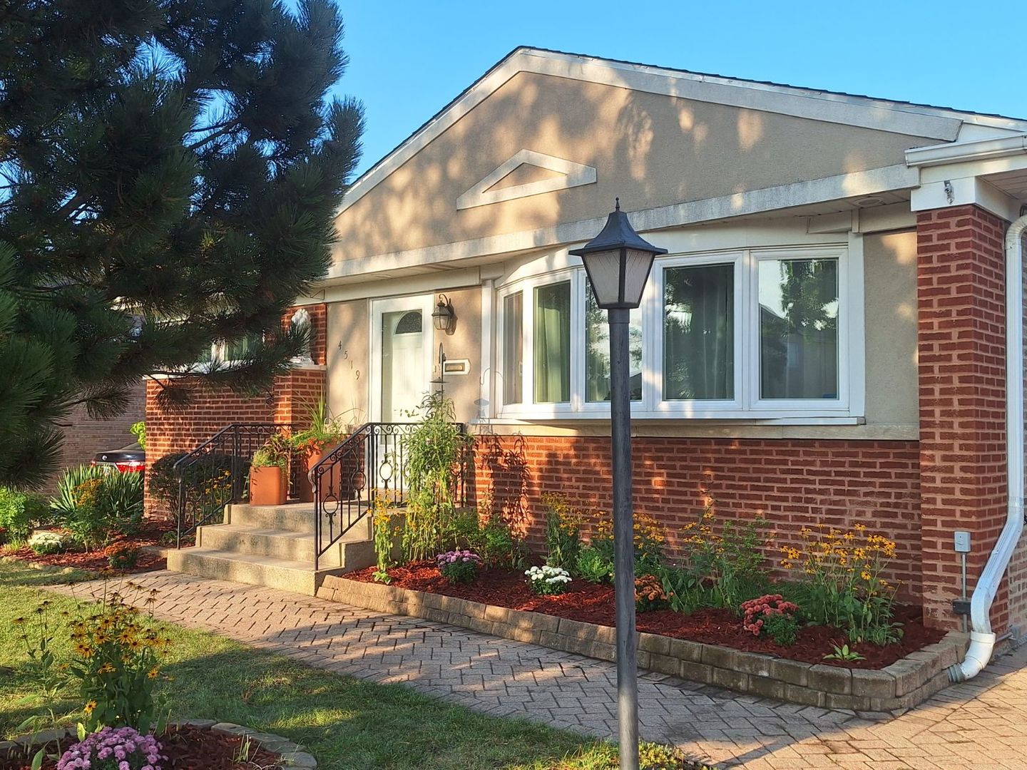 a view of a brick house with a yard