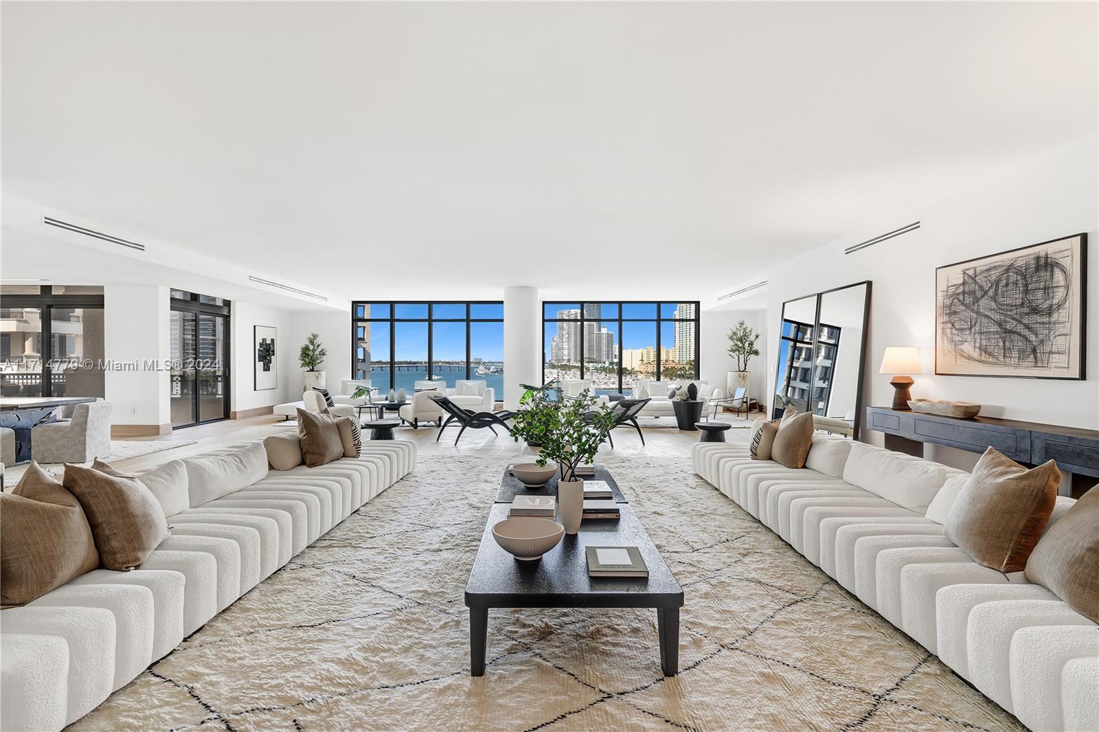 a living room with furniture potted plant and windows