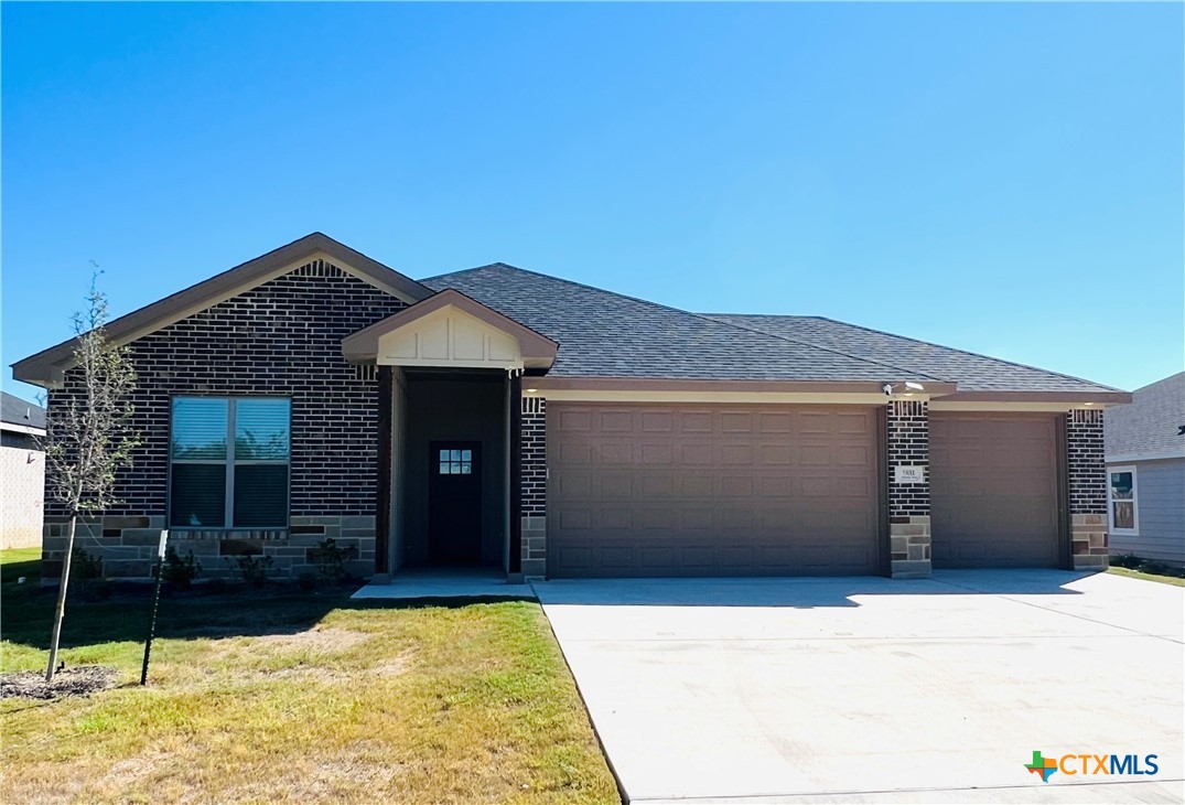 a front view of a house with garage