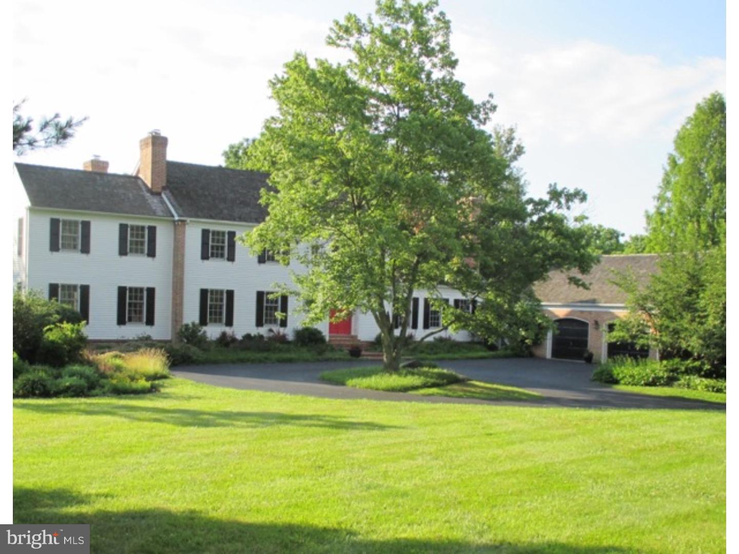 a front view of house with yard and trees