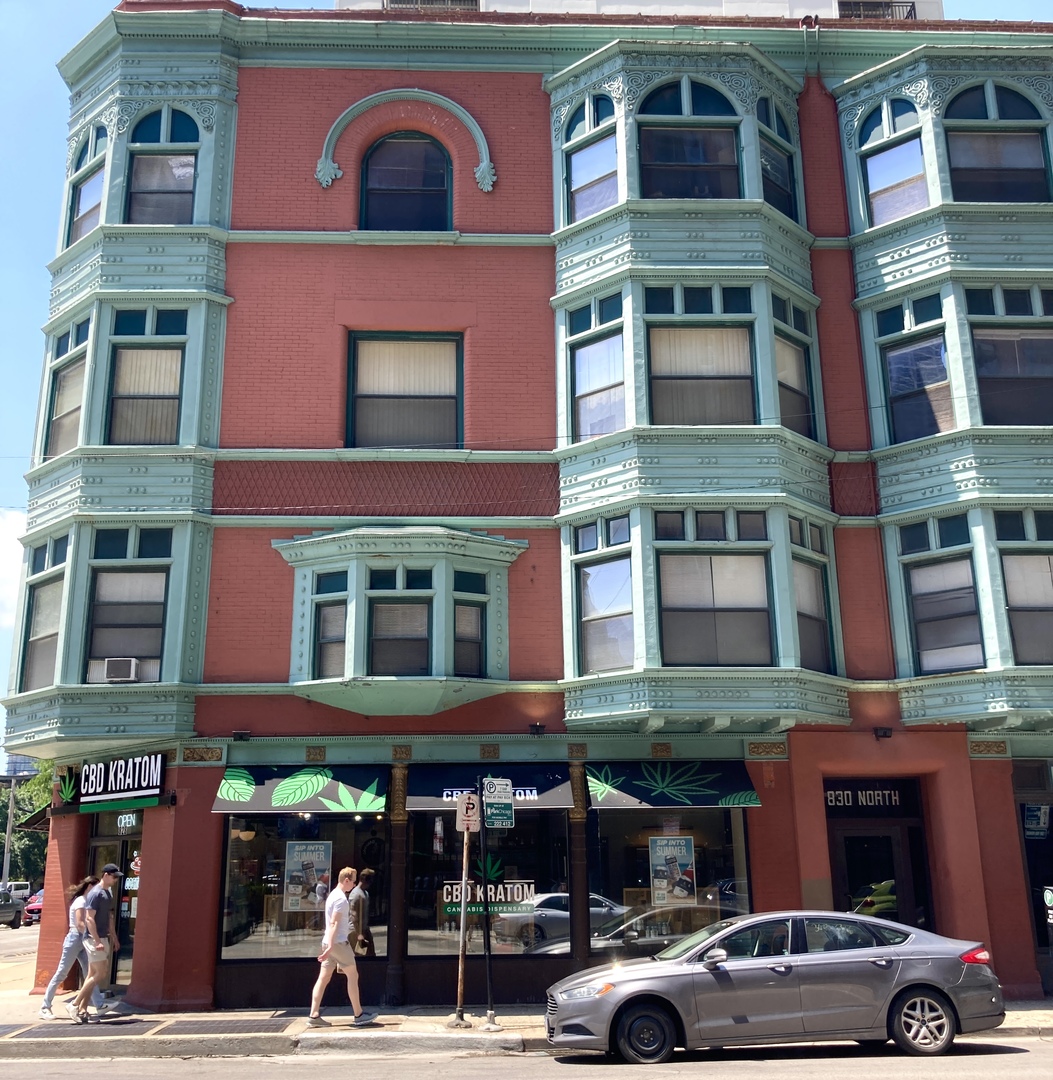 a front view of building with cars parked