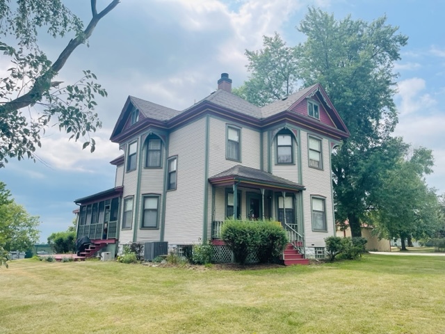 a front view of a house with a garden and plants